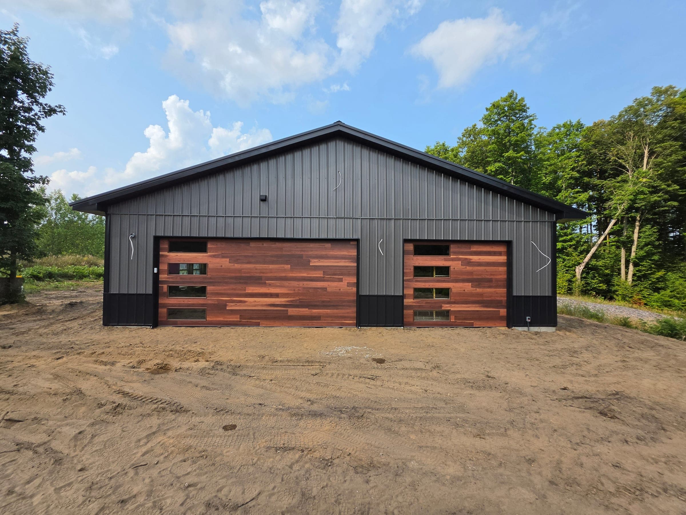 Richards-Wilcox honey cedar flush plank doors on a new steel building installed by B&B