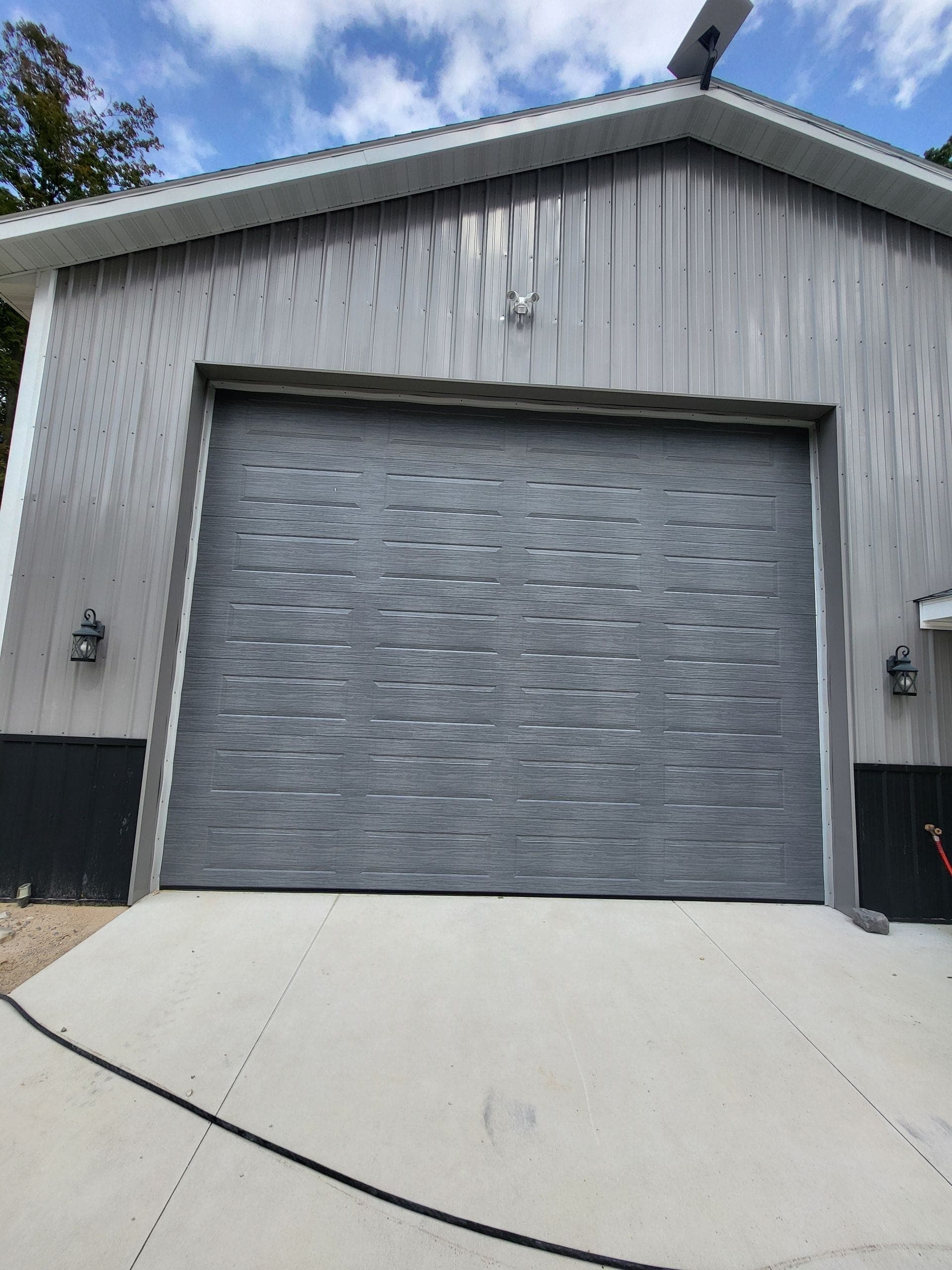 Tall gray overhead door on a steel building