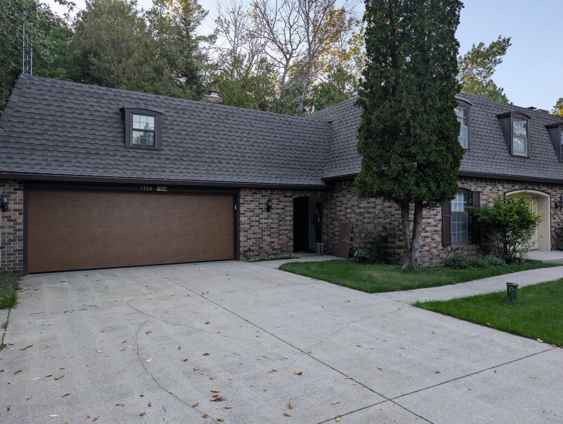 Brown garage door on a brick and siding ranch home